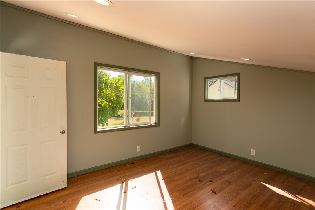 8949 Delta Line Road Custer, WA 98240 - Photo 28 of 39 a view of an empty room with wooden floor and a window