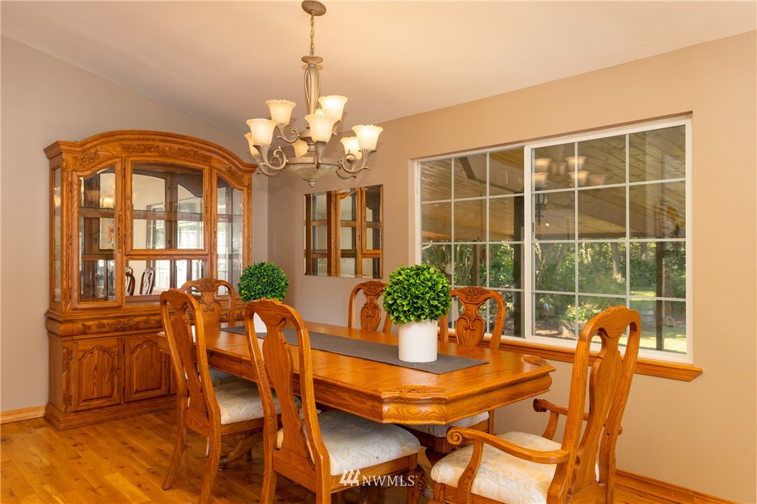 8949 Delta Line Road Custer, WA 98240 - Photo 7 of 39 a view of a dining room with furniture window and wooden floor