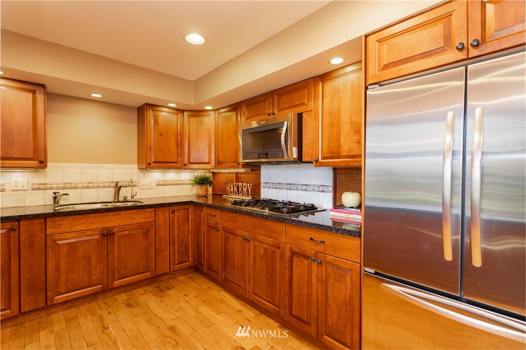 8949 Delta Line Road Custer, WA 98240 - Photo 10 of 39 a kitchen with stainless steel appliances granite countertop a refrigerator a stove and a sink
