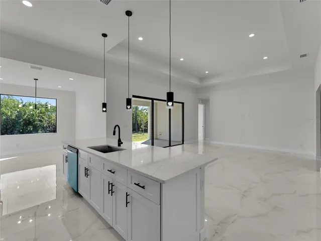a bathroom with a granite countertop sink mirror and bathtub