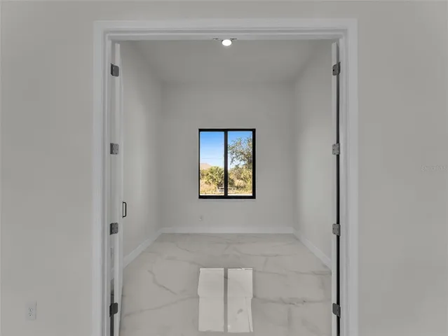 a view of an empty room with a window