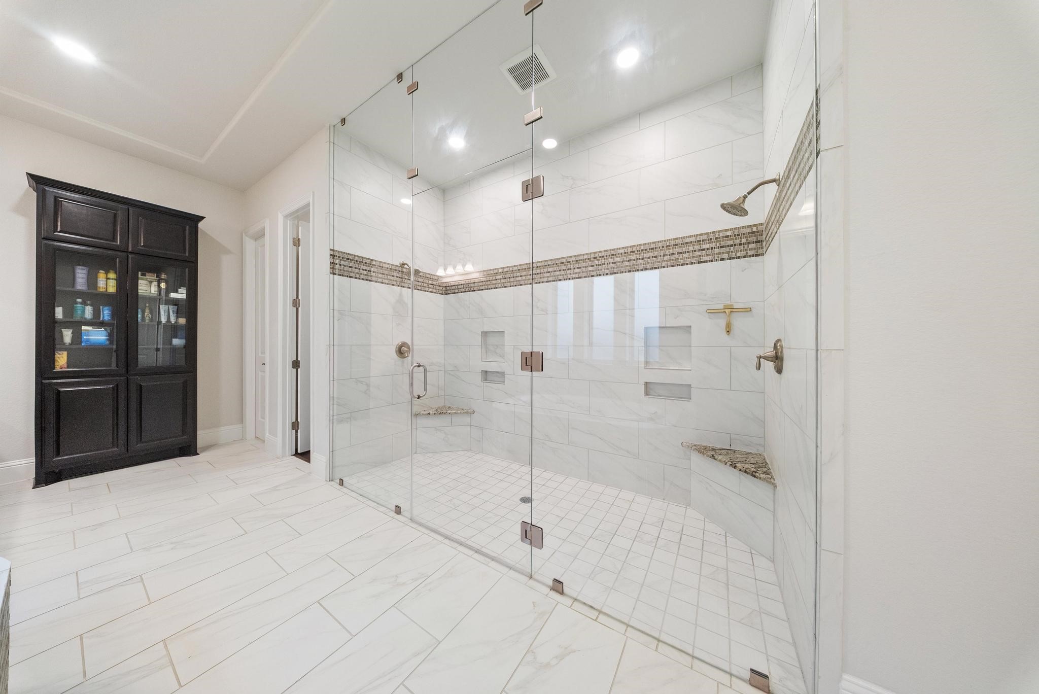 5403 Rouchel Brook Lane Sugar Land, TX 77479 - Photo 16 of 42 Oversized walk-in shower with designer tile work and dual shower heads.