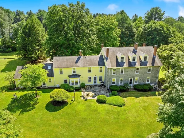 an aerial view of a house with yard basket ball court and outdoor seating