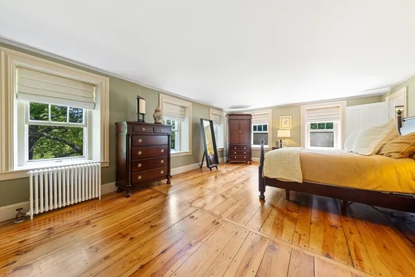 a bedroom with furniture and wooden floor