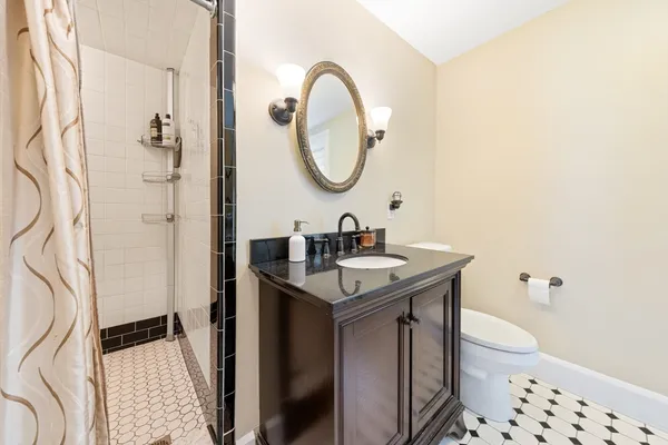 a bathroom with a sink a toilet and a mirror