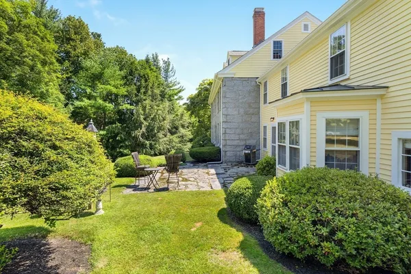 a view of backyard of house with green space