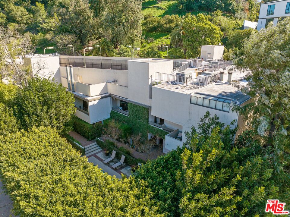 11687 Bellagio Road, Unit 5 Los Angeles, CA 90049 - Photo 1 of 31 a view of a house with pool and wooden fence