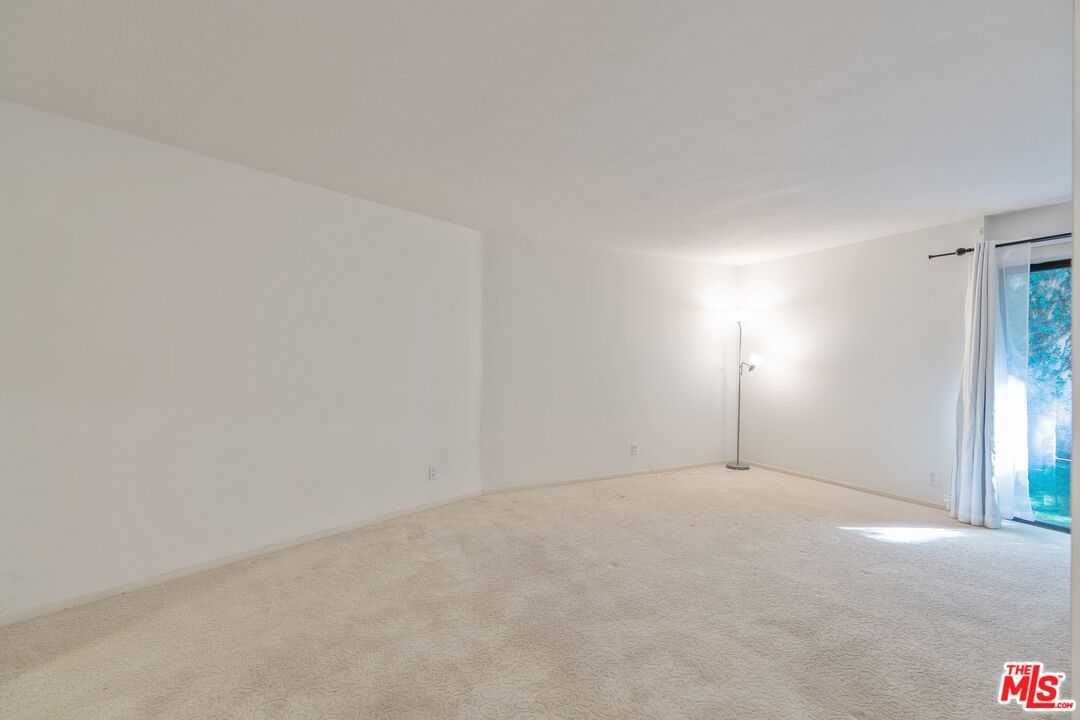 11687 Bellagio Road, Unit 5 Los Angeles, CA 90049 - Photo 16 of 31 a view of an empty room and window