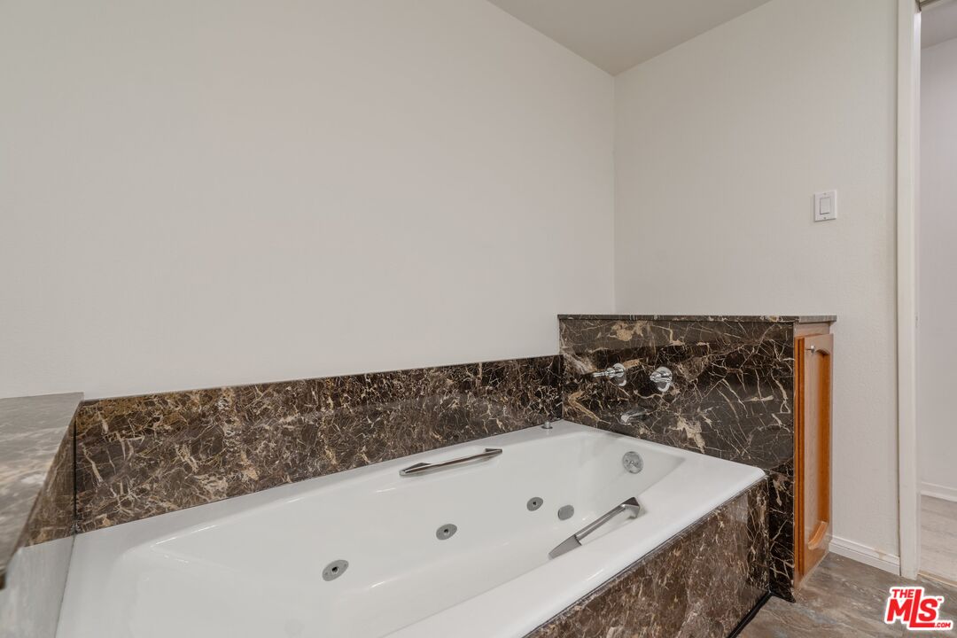 11687 Bellagio Road, Unit 5 Los Angeles, CA 90049 - Photo 20 of 31 a bath tub sitting in a bathroom