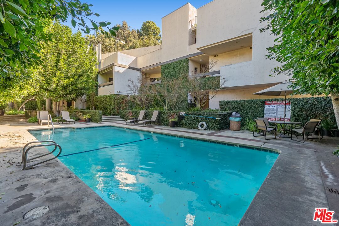 11687 Bellagio Road, Unit 5 Los Angeles, CA 90049 - Photo 2 of 31 a view of a house with swimming pool