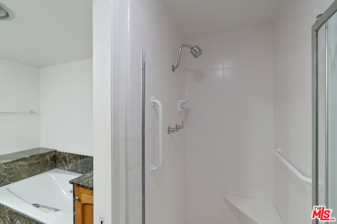 11687 Bellagio Road, Unit 5 Los Angeles, CA 90049 - Photo 21 of 31 a bathroom with a sink and shower