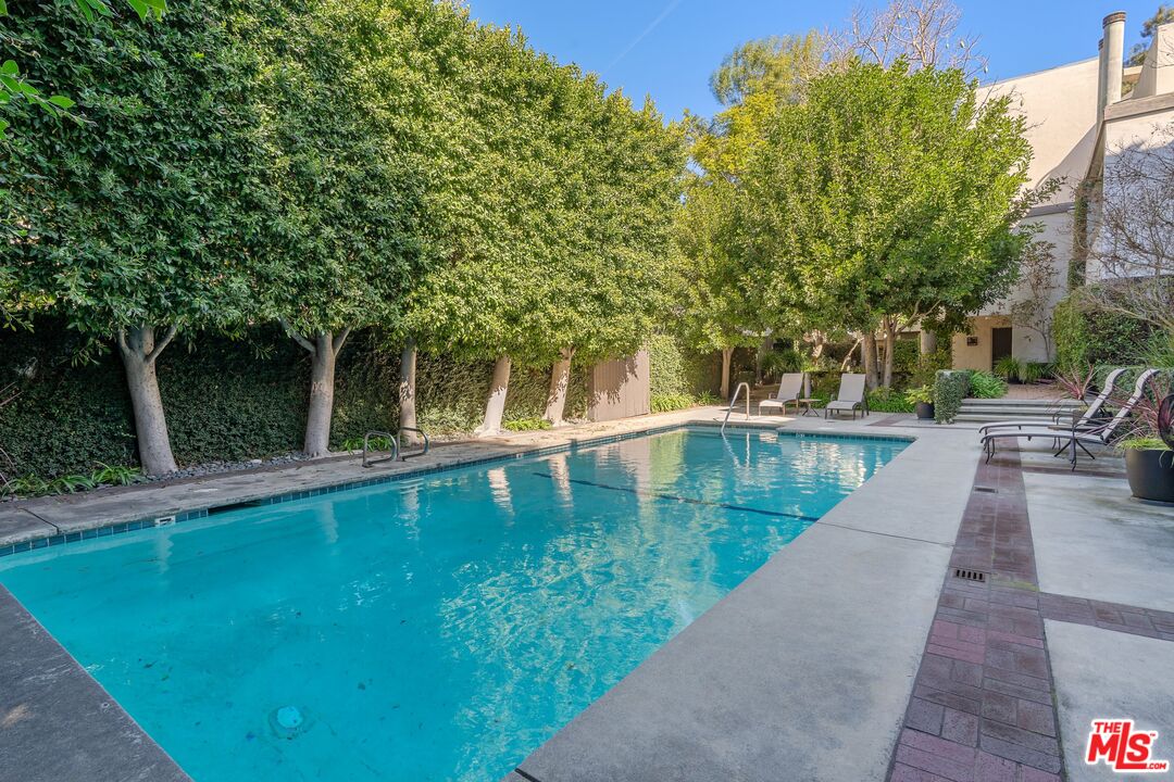 11687 Bellagio Road, Unit 5 Los Angeles, CA 90049 - Photo 29 of 31 a view of a swimming pool with a patio