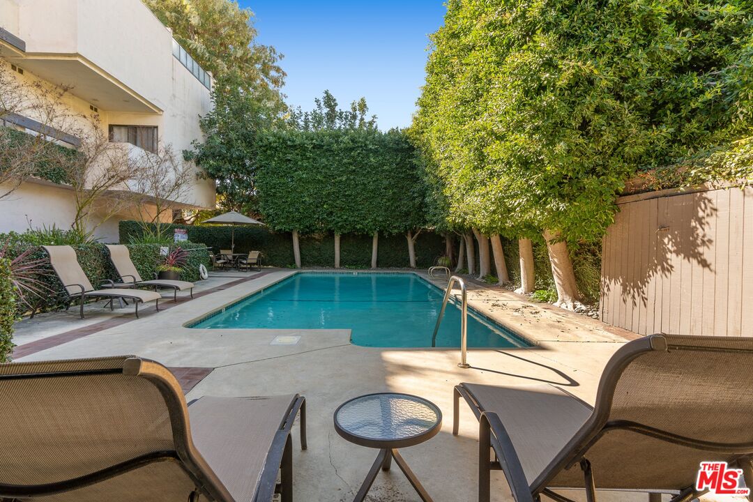 11687 Bellagio Road, Unit 5 Los Angeles, CA 90049 - Photo 30 of 31 a view of backyard with swimming pool and seating space