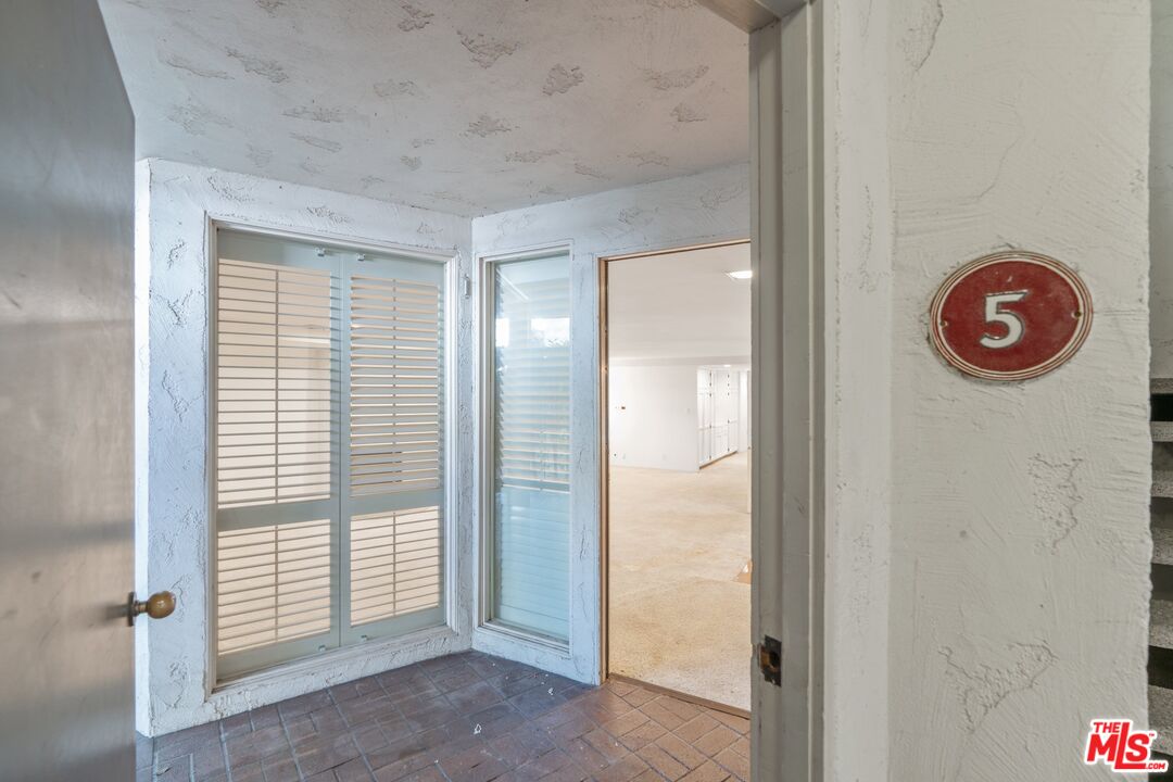 11687 Bellagio Road, Unit 5 Los Angeles, CA 90049 - Photo 3 of 31 an empty room with windows