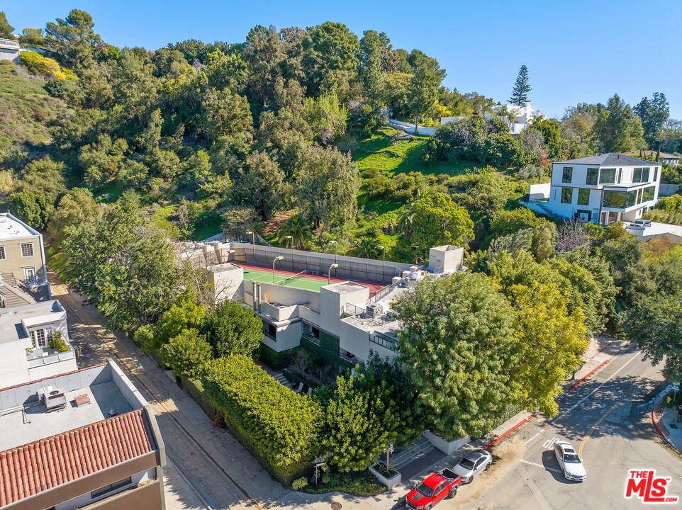 11687 Bellagio Road, Unit 5 Los Angeles, CA 90049 - Photo 31 of 31 a view of a house with a flower garden