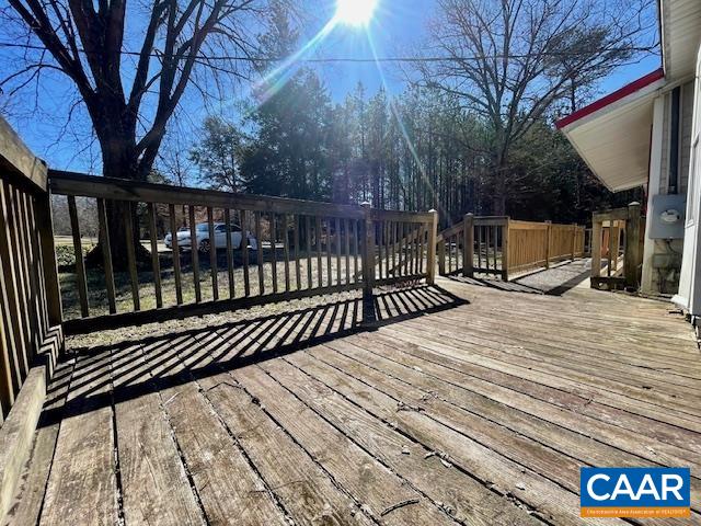 475 Liberty Road New Canton, VA 23123 - Photo 5 of 21 a view of balcony with wooden floor and fence and trees
