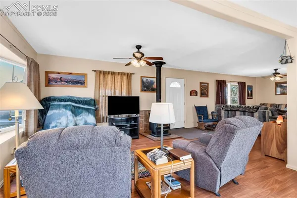 a living room with furniture a flat screen tv and a table