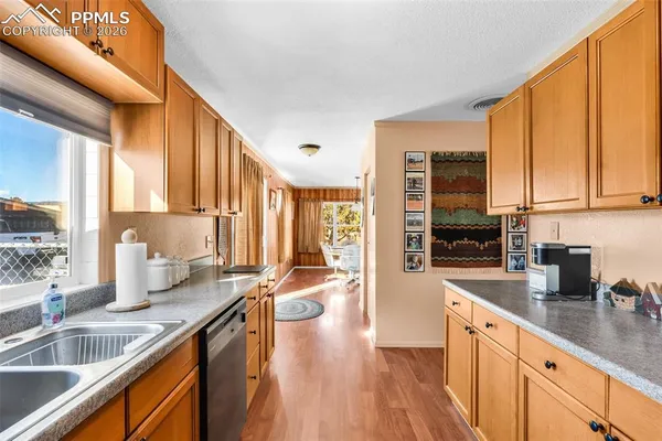 a kitchen with stainless steel appliances granite countertop a sink stove and cabinets