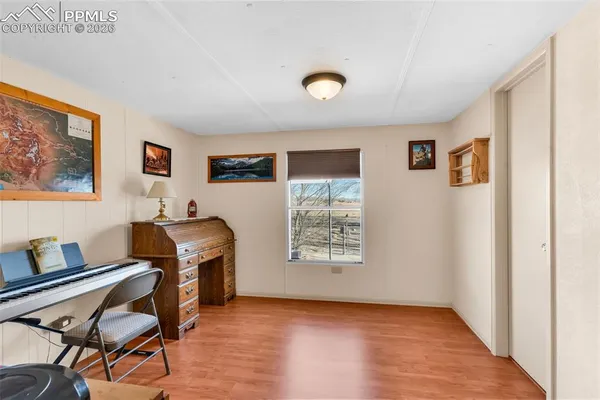 a view of workspace with wooden floor and furniture