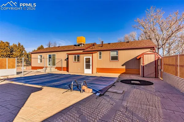a view of backyard with a table and chairs
