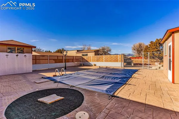 a view of a swimming pool with a lounge chair