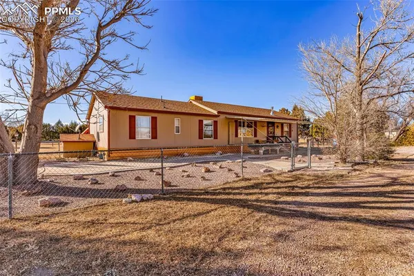 a view of a house with snow on the side of the road