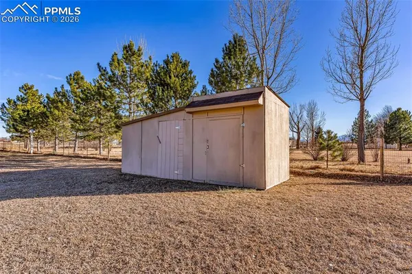a view of a house with a yard covered with snow in front of house