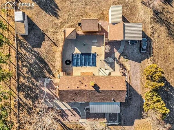 an aerial view of a house with a yard