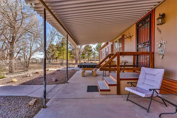 a view of a chairs and table in the patio