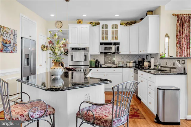 a kitchen with stainless steel appliances granite countertop a sink and cabinets