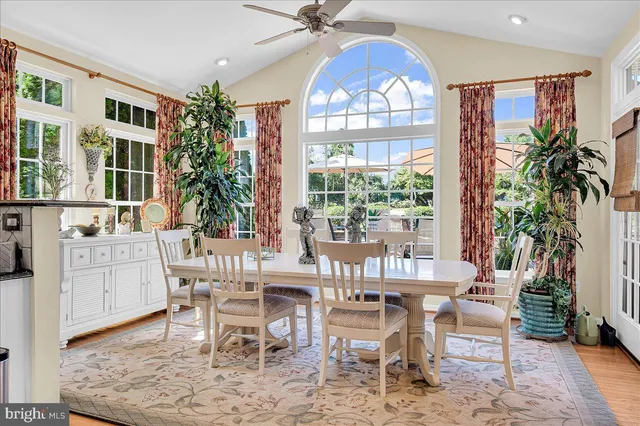 a dining room with furniture a chandelier and wooden floor