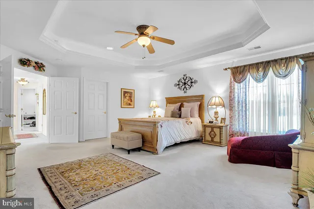 a bedroom with a bed and glass window