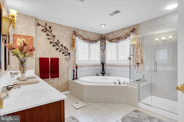 a bathroom with a tub sink and mirror