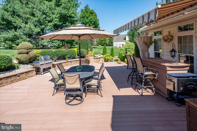 a view of outdoor dining space with furniture and wooden floor