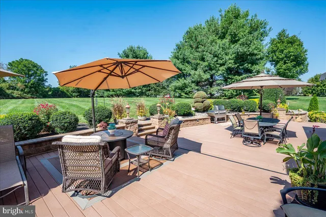 a view of a patio with chairs and table under an umbrella