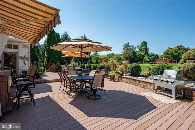 a view of backyard with outdoor seating and wooden floor
