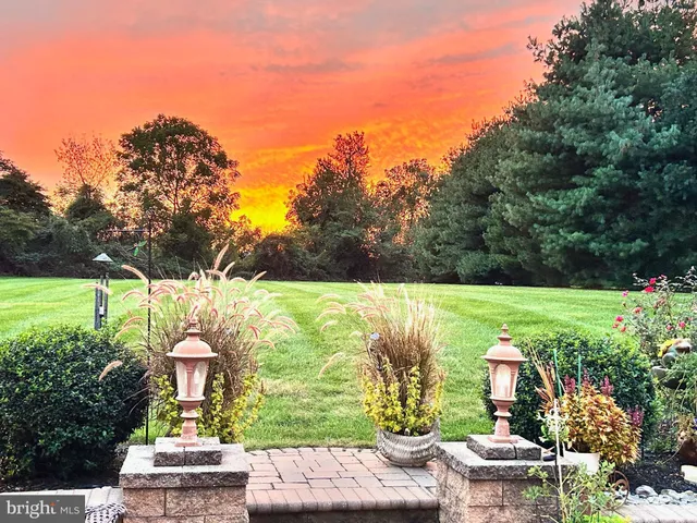 a view of a house with backyard sitting area and garden