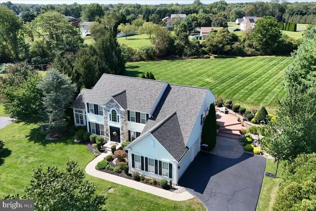 an aerial view of a house with a big yard