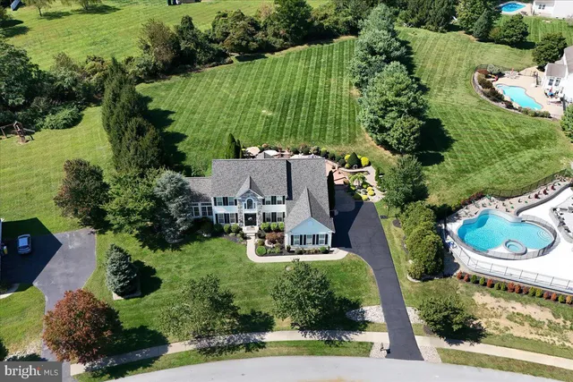an aerial view of a house with garden space and street view