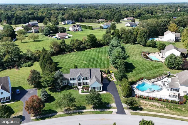 an aerial view of a house with yard