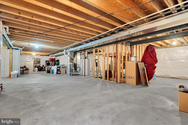 a front view of a house with a garden and trees