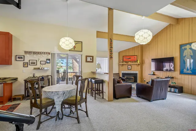 a view of a dining room with furniture and a large window