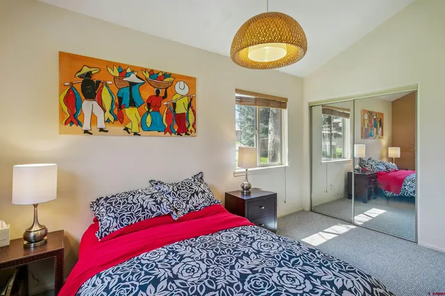 a bedroom with a bed and a painting on the wall