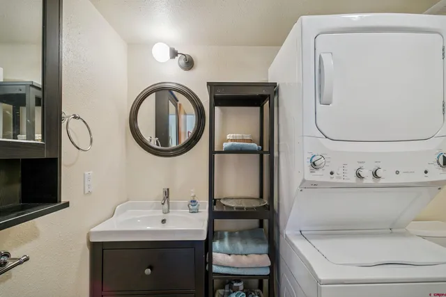 a bathroom with a sink mirror and toilet