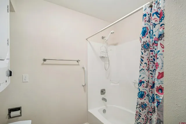 a bathroom with a shower curtain and a curtain