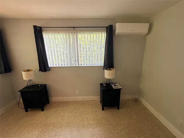 a room with a window and a bed