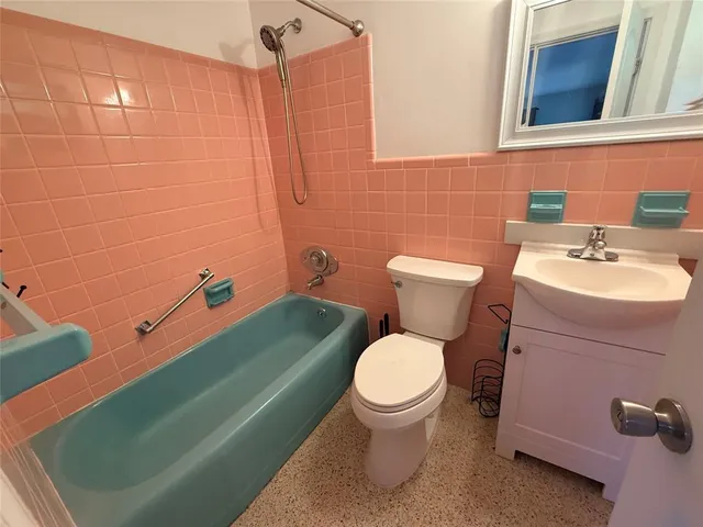 a bathroom with a sink toilet and a mirror