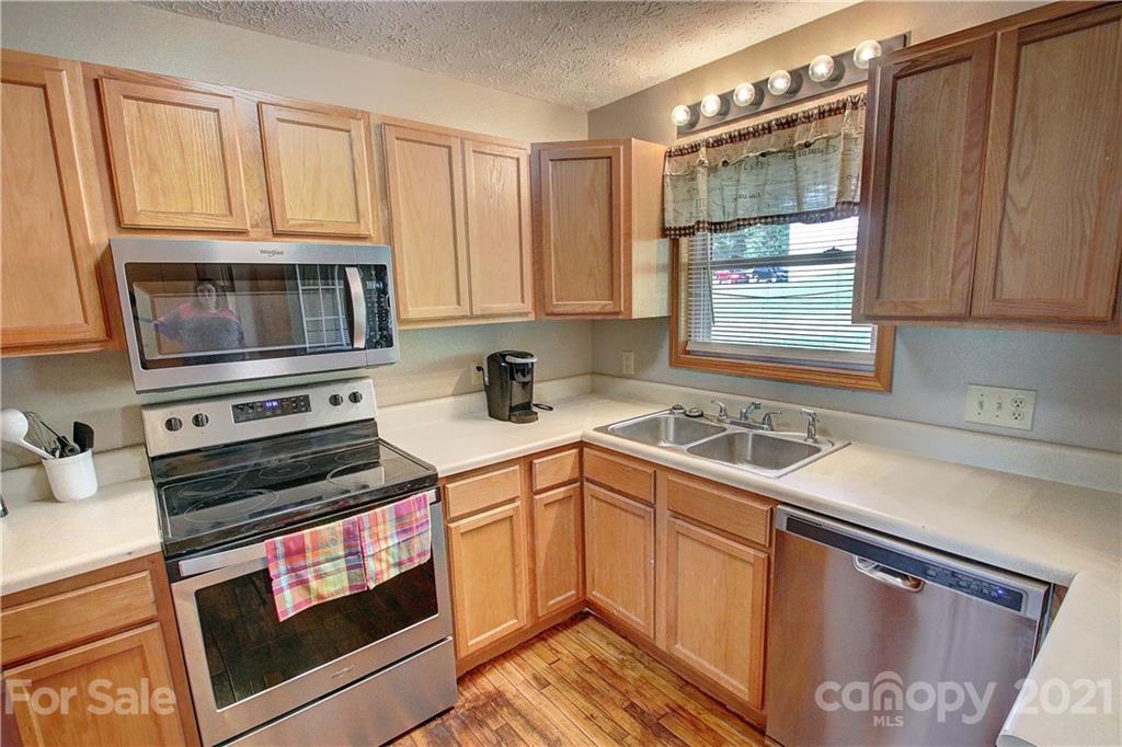 49 Sovereign Circle Clyde, NC 28721 - Photo 12 of 23 a kitchen with granite countertop a stove sink and microwave