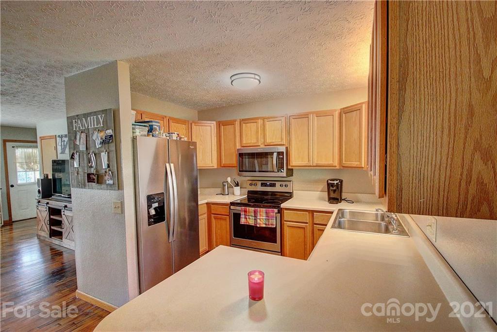49 Sovereign Circle Clyde, NC 28721 - Photo 13 of 23 a kitchen with stainless steel appliances granite countertop a refrigerator a stove top oven a sink and dishwasher