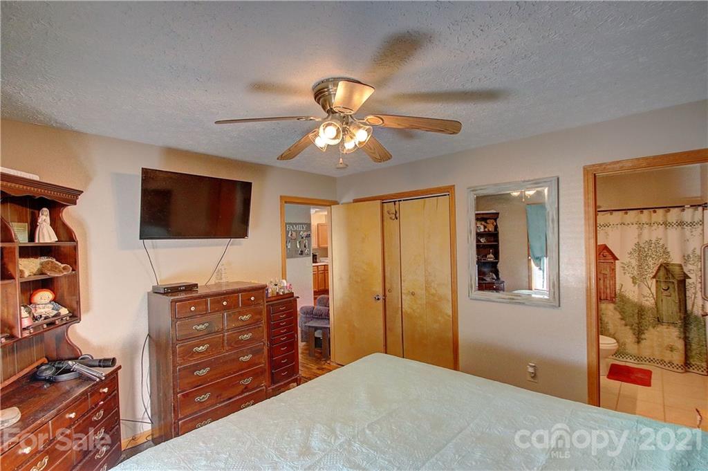 49 Sovereign Circle Clyde, NC 28721 - Photo 15 of 23 a bedroom with a bed and a flat screen tv